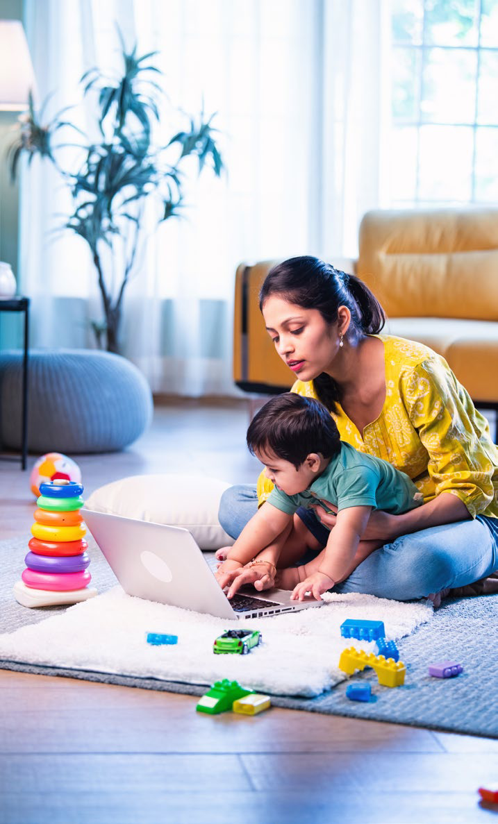 A mother and child using a laptop at home